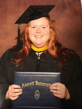 ashley in cap and gown with averett degree